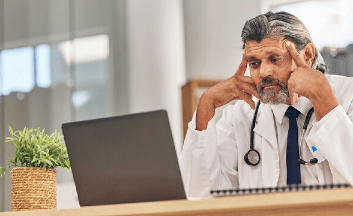 Doctor staring at laptop